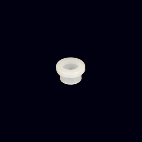 A white plastic cap sitting on top of a black table.