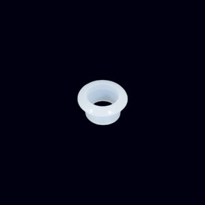 A white cup is sitting on the ground.